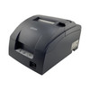 Three-quarters side profile of the Epson TM-U220B impact printer, displaying its compact curved housing, status panel, and power switch position.