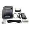 Complete contents package layout for the Epson TM-U220B printer including the dark gray printer unit, black ink ribbon cassette, Ethernet cable, power adapter brick, AC power cord, sample paper roll, and small hardware bag.