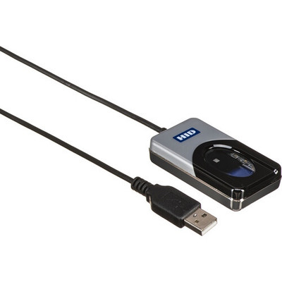 A high-angle perspective view of an HID DigitalPersona 4500 fingerprint reader with its attached USB cable. The device features a silver and black rectangular housing with an oval optical scanning area and a blue HID logo on the top surface. A long, thin black cable extends from the back of the reader, terminating in a standard USB-A male connector shown in the foreground.