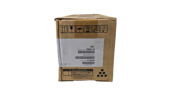 A close-up view of the short end of a brown cardboard printer cartridge box. A white identification label in the center displays technical details including "MODEL NO. D896-32," "EDP CODE 419078," and several barcodes. Above the label, a row of black handling icons indicates "this way up," "fragile," "keep dry," "stacking limit," "temperature limit (35°C/95°F)," and "protect from sunlight." The bottom of the box features Japanese text and a triangular pattern of six black dots.
