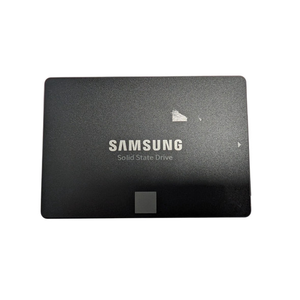 A top-down, full-frame studio shot of the front of a black Samsung 860 EVO 250GB 2.5-inch SATA III Internal Solid State Drive (SSD). The drive has a matte black finish with the "SAMSUNG" logo in bold, silver-white lettering in the center, and the words "Solid State Drive" printed in a smaller, thinner font directly below it. At the bottom center, there is a small, light gray square accent. On the right edge, a small white arrow points toward the SATA connection side. There is a small piece of white sticker residue or a minor scuff mark on the upper-right portion of the drive's face. The background is a solid, clean white.