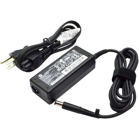 An HP laptop charger kit isolated on a white background. The kit features a rectangular black AC power brick with a detailed white regulatory text label containing a barcode. A built-in DC power cable extends from one side of the brick, neatly bundled with a black hook-and-loop strap, terminating in a large round barrel charging tip. Unattached on the left is a bundled black 3-prong AC wall power cord with a cloverleaf connector tip.