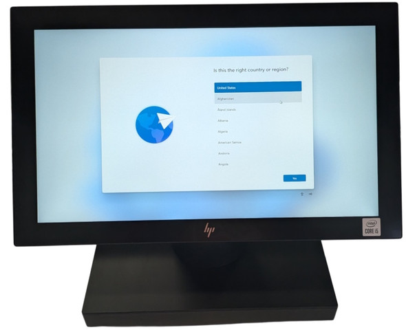 Front view of an HP Engage One Pro all-in-one touchscreen POS system on an expansion stand displaying the Windows 11 setup screen with an Intel Core i5 badge.