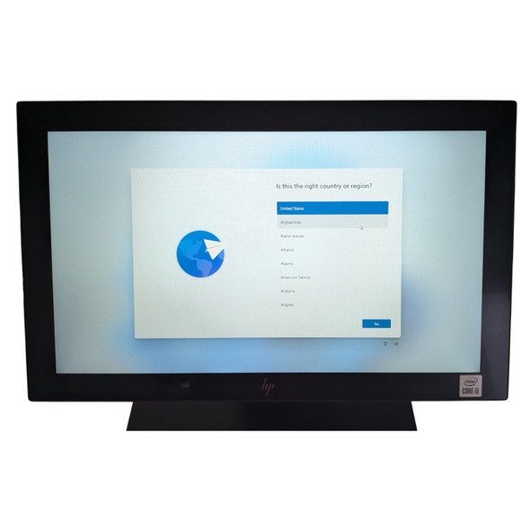 Close-up front view of the HP Engage One Pro touchscreen display powered on and showing the initial Windows 11 language selection screen.