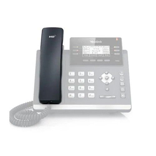A product view showcasing the black Yealink YEA-T42-HND replacement handset in sharp focus, sitting inside the cradle of a faded, light grey Yealink IP desk phone background. The top front of the handset features a prominent silver "HD" logo imprint, and a black coiled cord stretches from its base against a clean white backdrop.