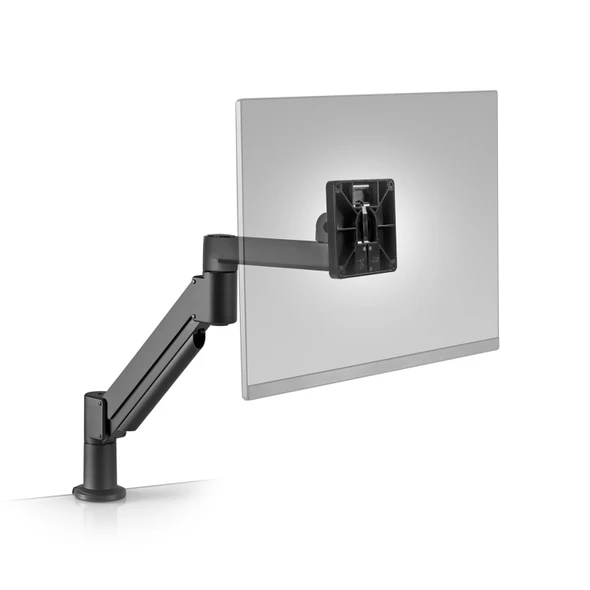 A product view of the Innovative 7Flex articulating radial swing monitor arm finished in textured Vista Black, shown mounted onto the edge of a clean desk surface against a crisp white background. The heavy-duty aluminum mechanical gas-spring arm segments flex upward to support a black VESA-compliant quick-release mounting plate plate attached to the back of a faded out, semi-transparent grey flat-panel display pane.