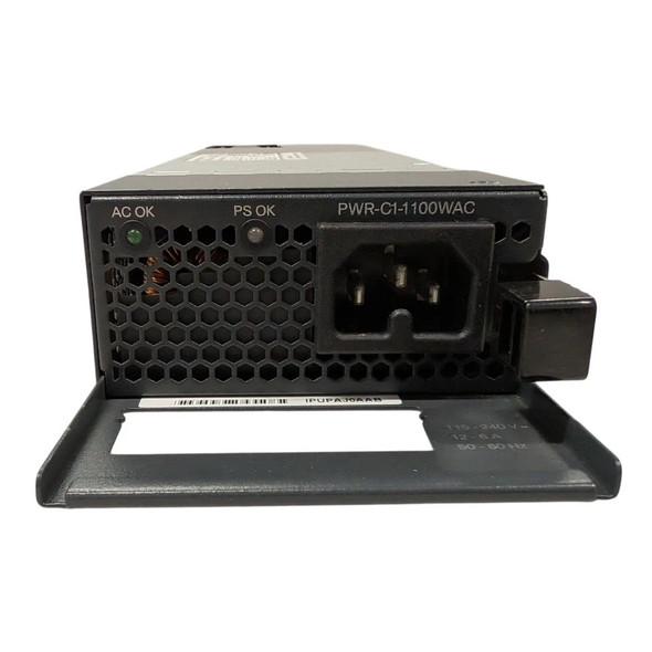 Angled front view of a silver Cisco PWR-C1-1100WAC power supply module showing its intricate connector pins and a large integrated cooling fan.