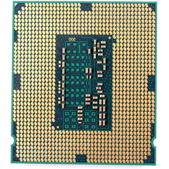Close-up underside view of an Intel LGA 1150 processor showing a grid pattern of gold-plated land contact pads across a green substrate base, surrounding a dark rectangular center section populated with small surface-mounted capacitors, resistors, and a "002" label designation.