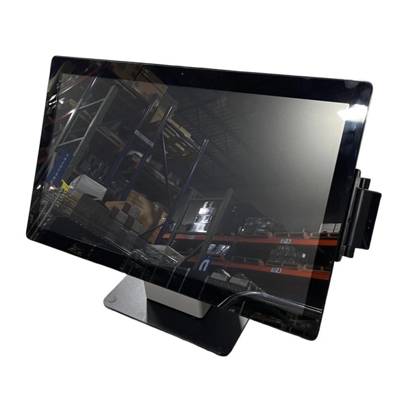 Front three-quarter view of an Elo I-Series 21.5" touchscreen POS terminal on a black desktop stand. A black magnetic stripe reader (MSR) is attached to the right side of the gloss-finish bezel, which shows a reflection of industrial warehouse shelving.