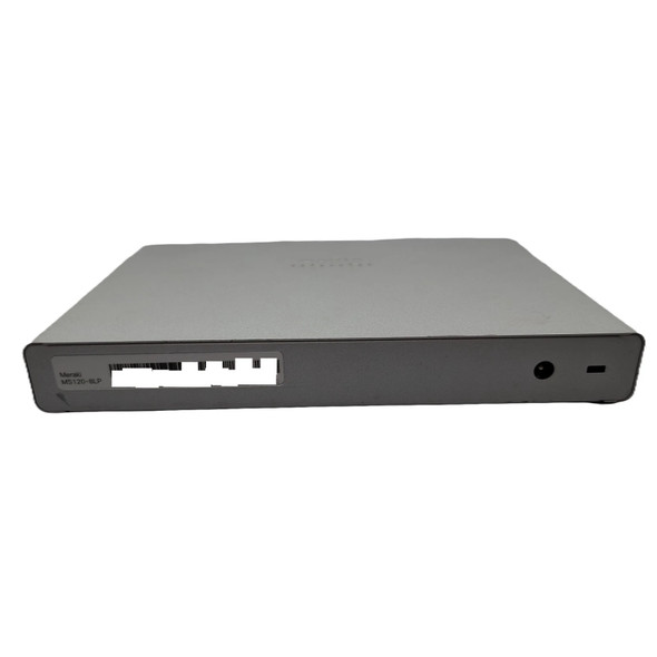 Rear perspective view of a silver Cisco Meraki MS120-8LP switch, showing the clean back panel with a round DC power input jack, a Kensington security slot, and a product label with a digitally blanked-out serial number barcode.