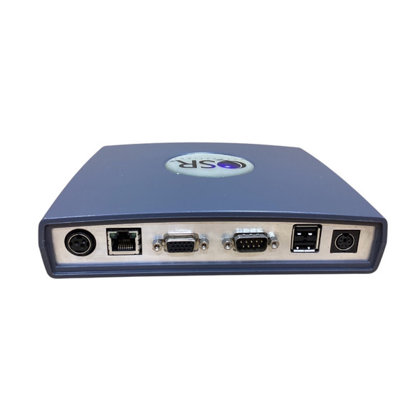 Rear connectivity panel of a QSR Automations DE-4100 kitchen controller showcasing available interface ports, including a PS/2 port, an RJ45 Ethernet LAN port, a VGA video output, a serial COM port, dual USB ports, and a round DC power input.