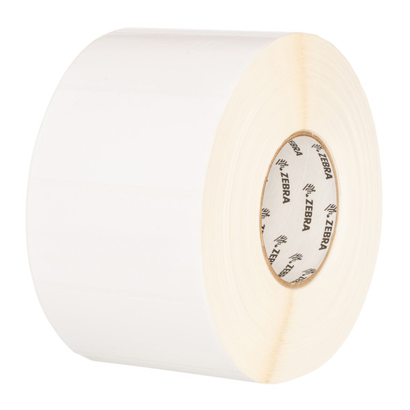 A close-up, angled view of a roll of blank, matte white Zebra Z-Select 4000D direct thermal labels, showing the internal 1-inch cardboard core printed with the repeating Zebra logo.