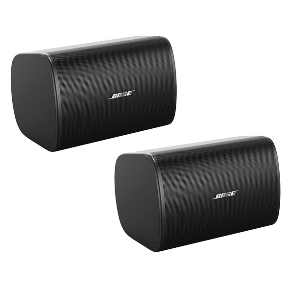 Pair of black Bose Professional DesignMax DM5SE surface-mounted loudspeakers displayed at a three-quarter angle on a white background.