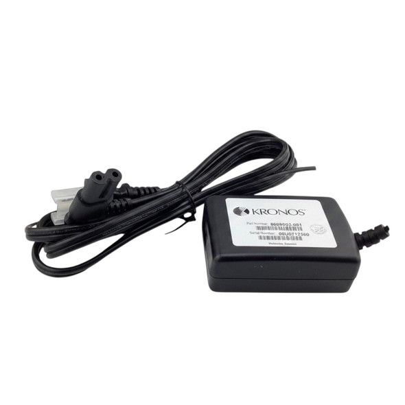 Bottom view of black Kronos 8609002-001 power adapter brick highlighting the official Kronos product label and attached AC power cord.