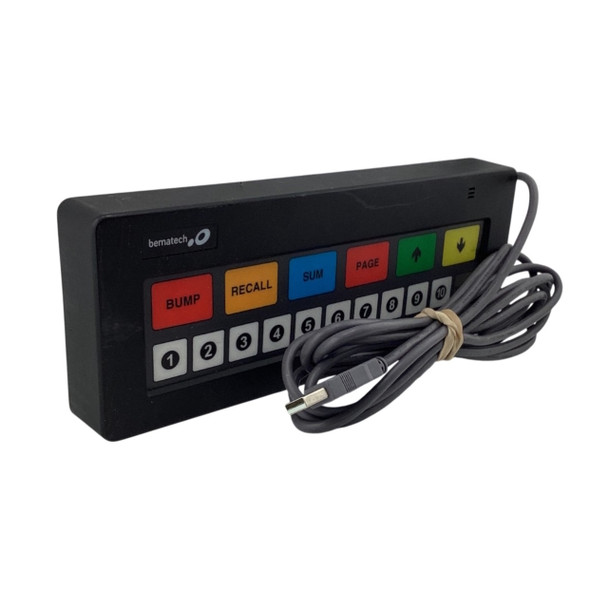 Front perspective view of a black Bematech Logic Controls KB1700 kitchen display bump bar featuring color-coded keys and a bundled USB cable.