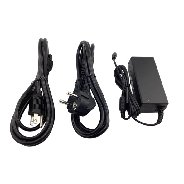 Top view showing the power brick next to two bundled AC power cables featuring US 3-prong and European 2-prong wall plugs.