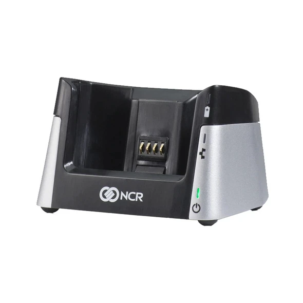 Front angle view of the NCR Orderman7 Service Station Model 7777-SC (7777-0203-8801) black and silver charging cradle with LED status indicators.