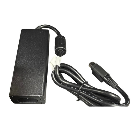 A top-down, slightly angled view of a genuine Datalogic 90ACC0196 AC/DC power supply brick, shown with its attached DC output cord against a solid white background. The rectangular matte black plastic adapter block features an unpopulated 3-prong IEC C14 power inlet at its base. The thick black output cable exits from the top, passing through a cylindrical ferrite core before being gathered in a loose bundle secured by a black twist tie. The cable terminates in a specialized, black 3-pin power connector tip.