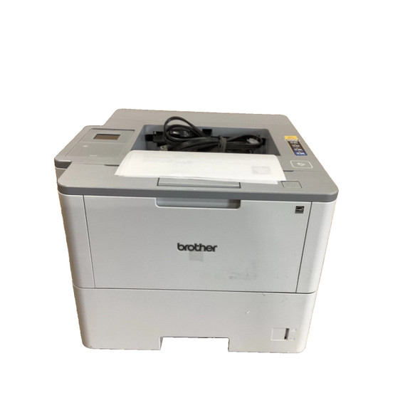 Front perspective view of the Brother HL-L6400DW monochrome laser printer displaying the 520-sheet lower paper tray, front multipurpose access door, top output tray, and touchscreen control panel with power cable placed on top.