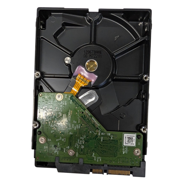 Rear underside view of Western Digital AV-GP 1TB 3.5-inch hard drive WD10EURX showing green printed circuit board, spindle motor, and SATA interface connectors