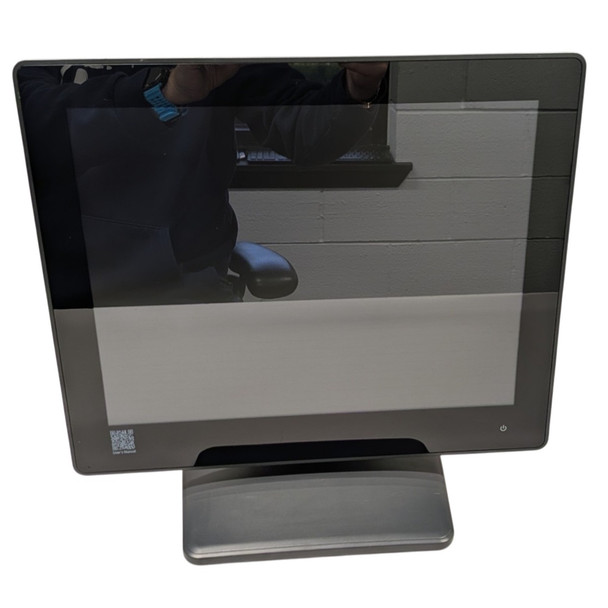 Front view of a charcoal POSBANK APEXA TL 15" touch POS terminal, featuring a true-flat bezel-free display and a sturdy desktop stand.