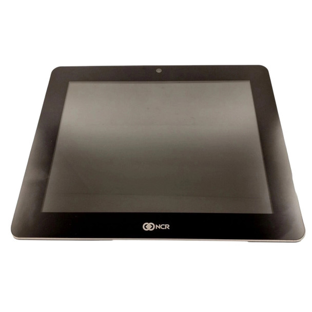 Straight-on front view of the ncr-counterpoint-realpos-xr7-touchscreen-pos-terminal-windows-10-iot-no-stand-7702-2515-front.jpg all-in-one terminal head. The device has a clean black zero-bezel glass surface with a central webcam at the top and a silver NCR logo printed along the bottom bezel edge.