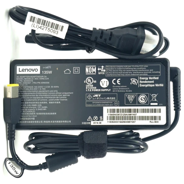 Close-up view of the specification label on the back of the Lenovo 135W AC power adapter, showing output ratings, safety certifications, and model information