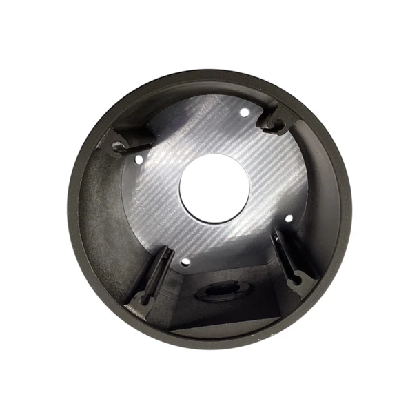 Top-down interior view of the Digital Watchdog DWC-BLJUNC junction box showing the hollow aluminum housing, mounting screw channels, and central cable access hole.