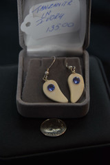 Alaskan Native crafted ivory with a sparkling round shaped natural Tanzanite as center stone of this earring set