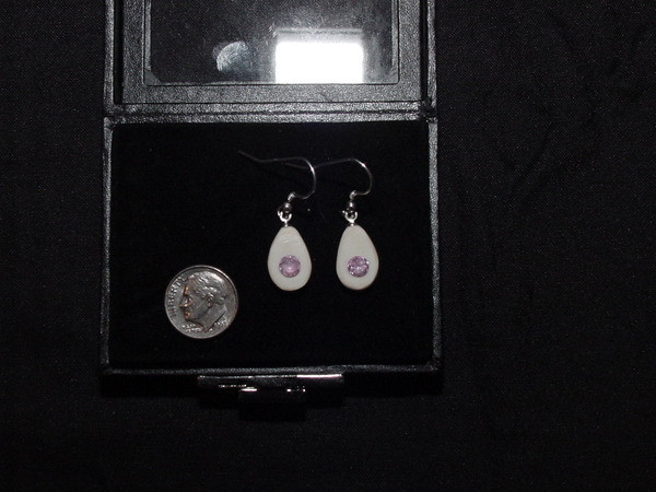 Alaskan Native crafted ivory with round cut natural bright purple pink tourmaline as center stones of this earring set.