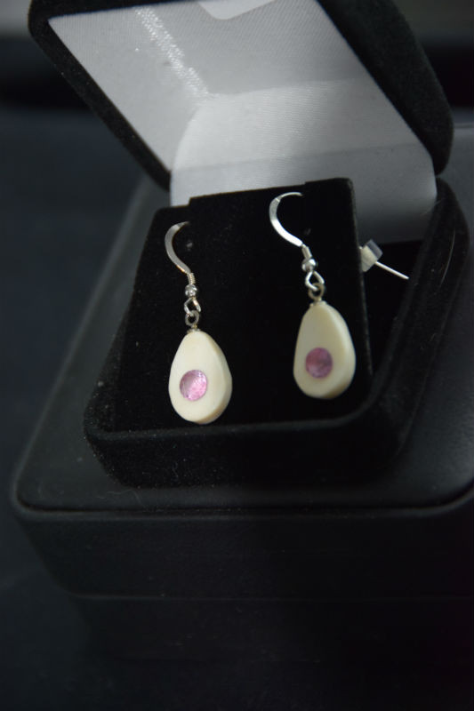 Alaskan Native crafted ivory with round cut natural bright purple pink tourmaline as center stones of this earring set.
