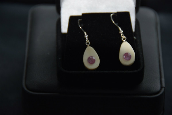 Alaskan Native crafted ivory with round cut natural bright purple pink tourmaline as center stones of this earring set.