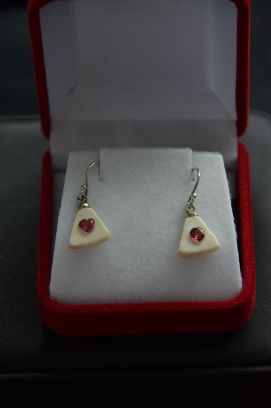 Alaskan Native crafted ivory with a sparkling petite red heart shaped natural Rhodolite as center stones of this earring set
