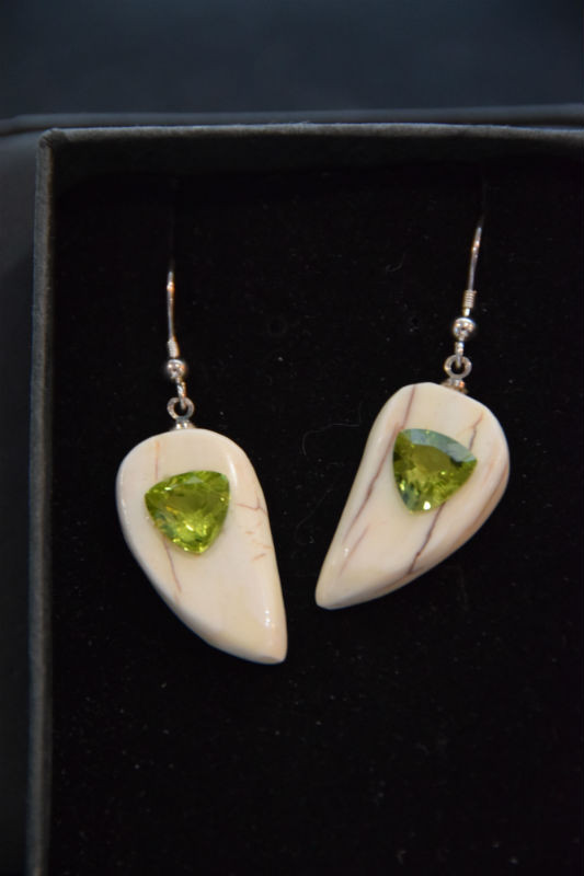 Alaskan Native crafted ivory with natural green Peridot Trillion Cut gems in a unique and stunning earring set