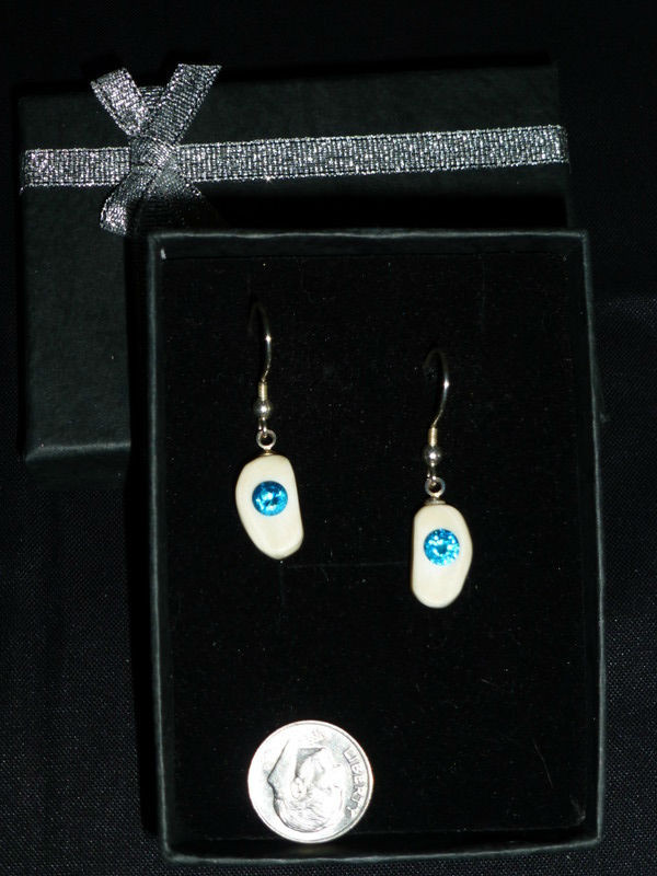 Alaskan Native crafted ivory with a lab-created, round shaped, beautifully faceted teal blue diamond as center stones of this unique earring set