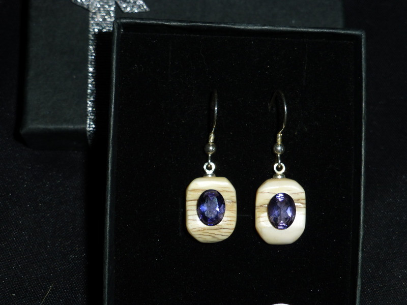 Alaskan Native crafted ivory with oval-shaped natural Iolite as center stone of this earring set