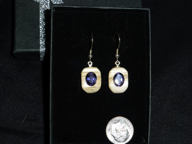 Alaskan Native crafted ivory with oval-shaped natural Iolite as center stone of this earring set