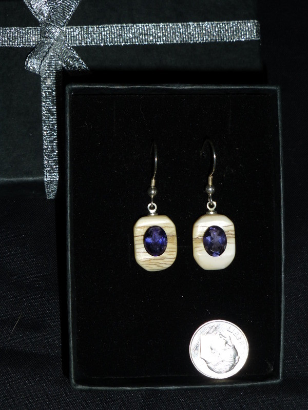 Alaskan Native crafted ivory with oval-shaped natural Iolite as center stone of this earring set