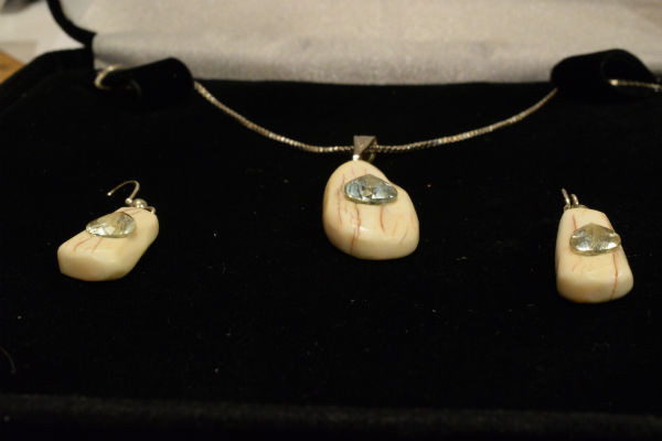 Alaskan Native crafted ivory with pear cut natural green Beryl as center stones of this stunning earring pendant set