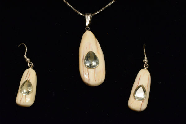 Alaskan Native crafted ivory with pear cut natural green Beryl as center stones of this stunning earring pendant set
