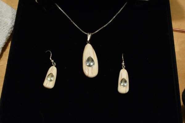 Alaskan Native crafted ivory with pear cut natural green Beryl as center stones of this stunning earring pendant set