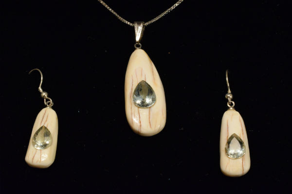 Alaskan Native crafted ivory with pear cut natural green Beryl as center stones of this stunning earring pendant set