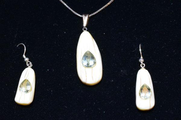 Alaskan Native crafted ivory with pear cut natural green Beryl as center stones of this stunning earring pendant set
