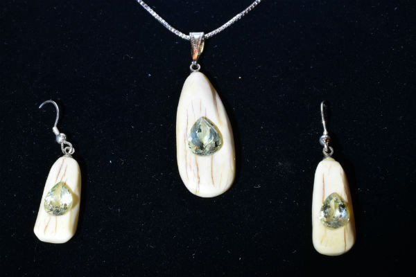 Alaskan Native crafted ivory with pear cut natural green Beryl as center stones of this stunning earring pendant set