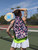 Pickleball player wearing Taboo Fashions Ladies Poppin Bottles Pickleball Bag on the court 