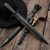 Battlecry Arkansas Toothpick knife with blackened steel blade and leather sheath.