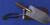Historical US Army entrenching tool featuring a wooden handle.