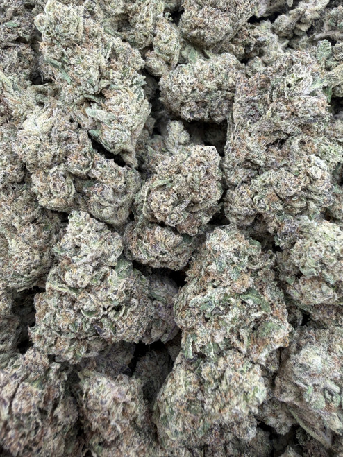 Racing Gaz is a premium top-shelf cultivar featuring dense, chunky buds blanketed in a thick layer of glistening trichomes. Rich emerald-green flowers with subtle purple accents and vibrant orange pistils create exceptional bag appeal, showcasing its high-quality craftsmanship. Its terpene profile bursts with bold notes of pungent diesel, sweet citrus, earthy pine, and a hint of creamy spice, delivering a smooth, flavorful smoke with a lingering gassy finish. Racing Gaz provides a powerful, well-balanced experience that begins with an uplifting wave of euphoria and mental clarity before easing into a soothing full-body relaxation, making it an excellent choice for those seeking bold flavor, premium bag appeal, and long-lasting effects.
