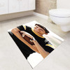 Zac Efron holding football bath rugs