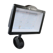 83W Outdoor LED Flood Light in Black/Bronze finish mounted on exterior wall.  LED flood light illuminating a parking lot at night.